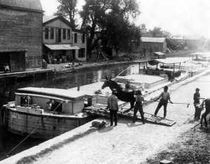 Title: Erie Canal scene, Fultonville [photograph]. Photographer/Artist: Gayer, Albert. Date: ca. 1900. Physical Details: 1 photograph : b&w ; 7 x 9 in. Collection: Perinton Municipal Historian collection Summary: Several men stand near a mule about to board a packet boat on the Erie Canal in Fultonville, New York. Mules would wear tow ropes attached to the boats traveling on the canal. As the mules walked down the towpath next to the canal, they would pull the boats along. Image Number: tpm00182 http://www.rochester.lib.ny.us/rochimag/perinton/ tpm/tpm00/tpm00182.jpg
